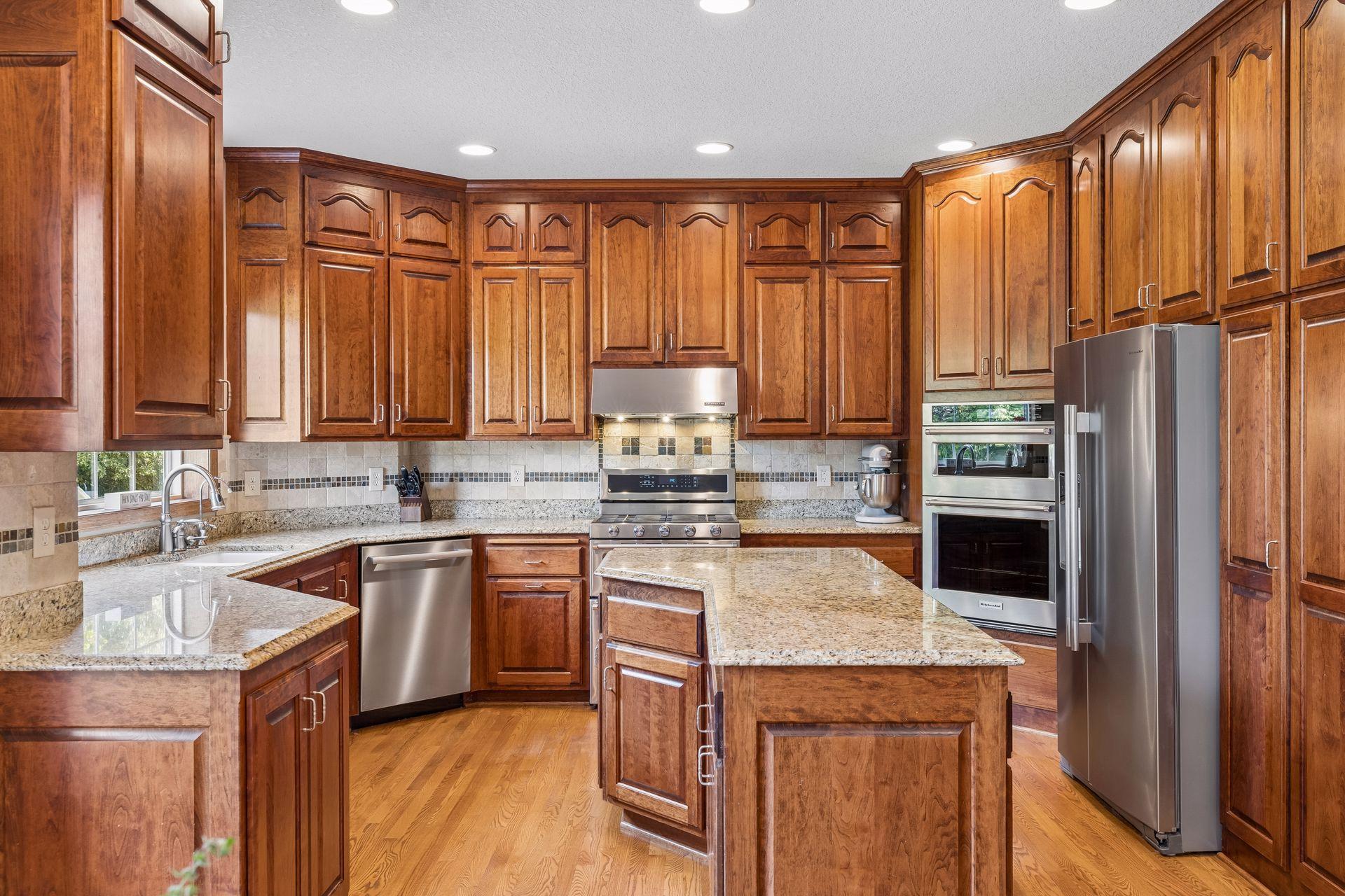 Extensive custom cabinetry provides ample space for storage and organization. The pantry cabinetry features roll-out shelving for ease.
