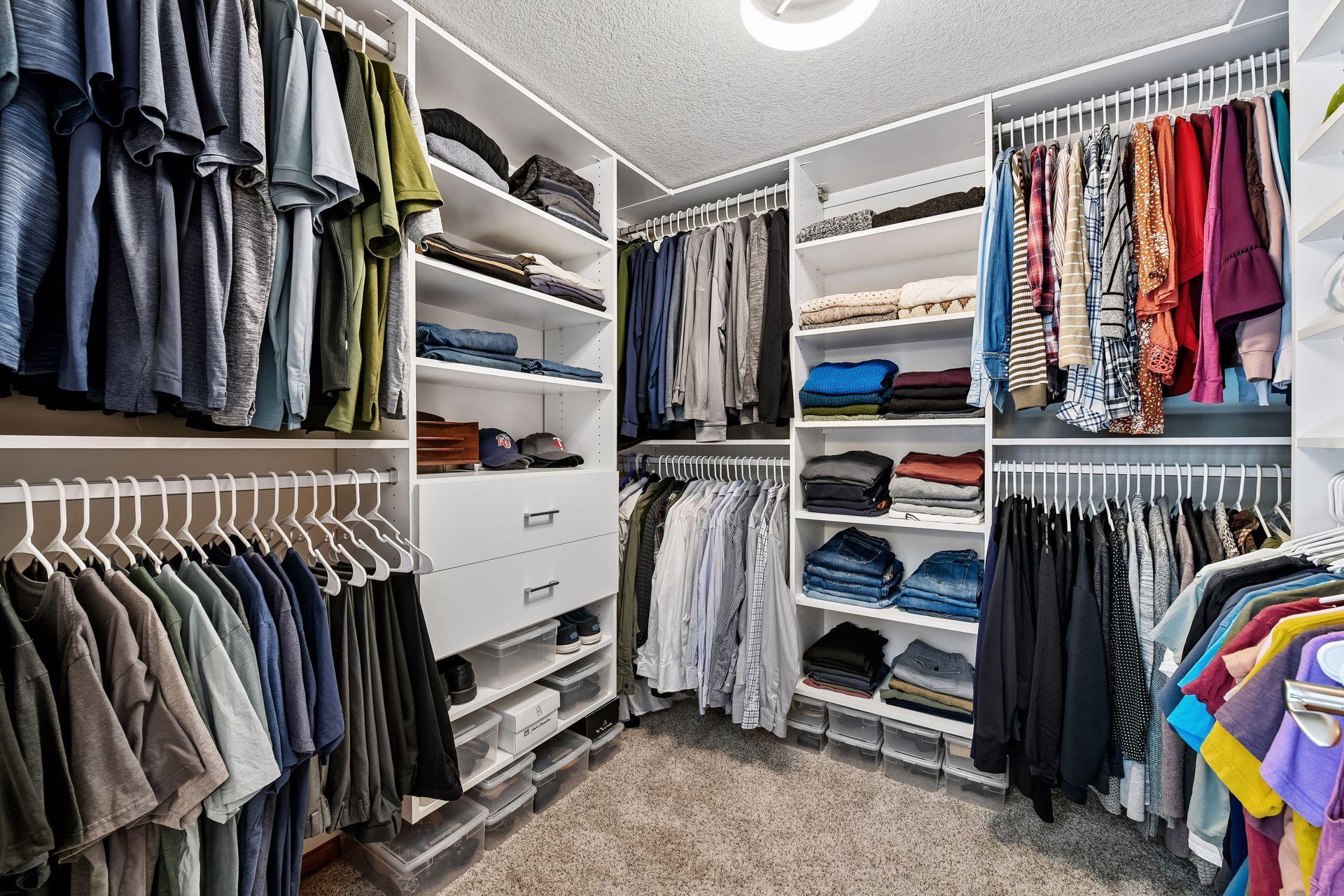 The walk-in closet features a custom organizer system.