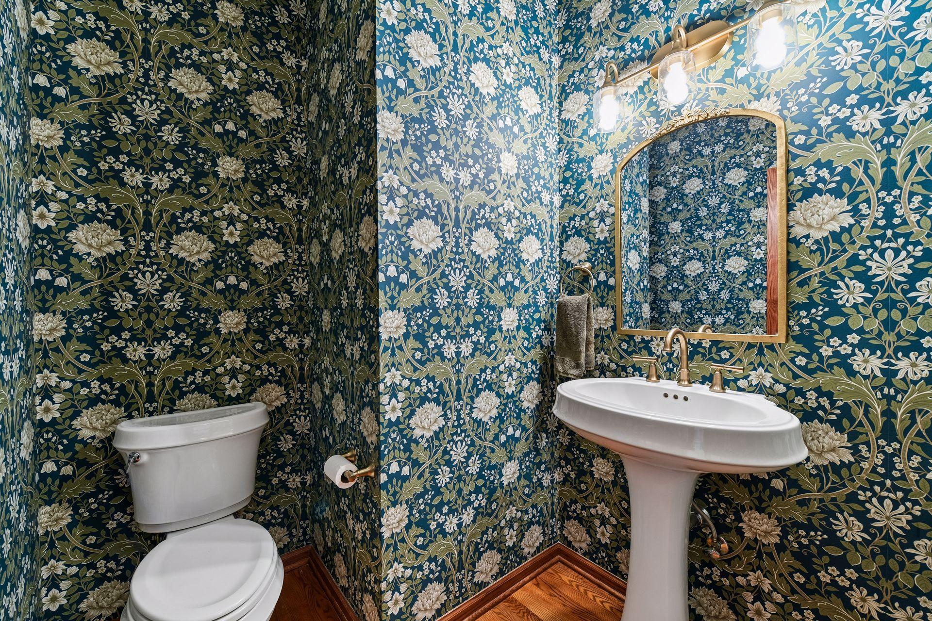 A charming Powder Room - this space has been updated with all new designer wall coverings and new fixtures.
