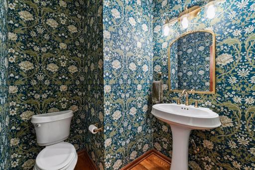 A charming Powder Room - this space has been updated with all new designer wall coverings and new fixtures.