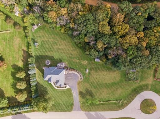 Surrounded by towering trees, this home enjoys a private setting.