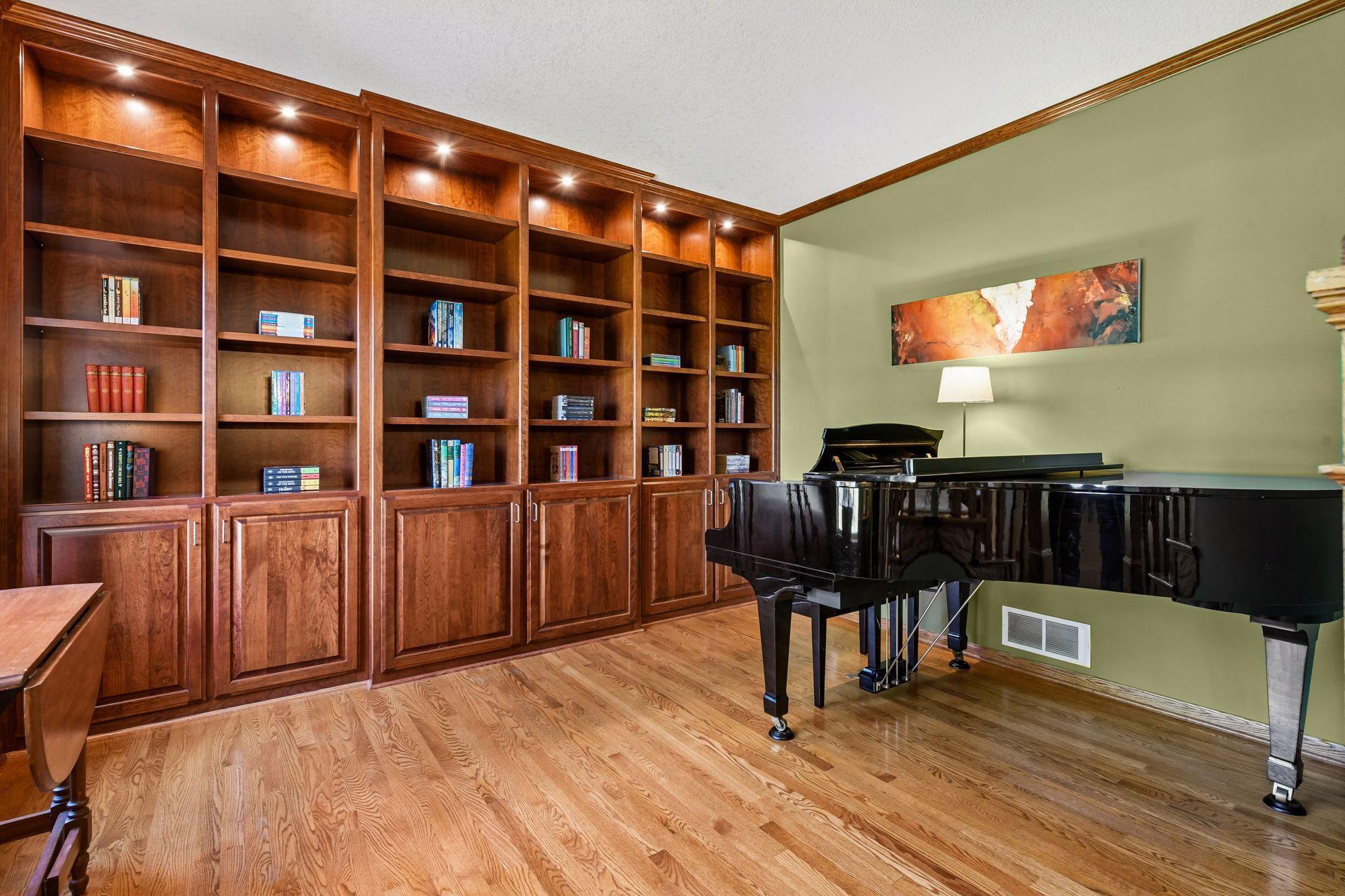 The Home Office is currently used as a music room and features crown molding and wall-to-wall built-ins.