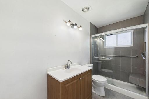 Full-sized bathroom equipped with a benched walk-in shower.