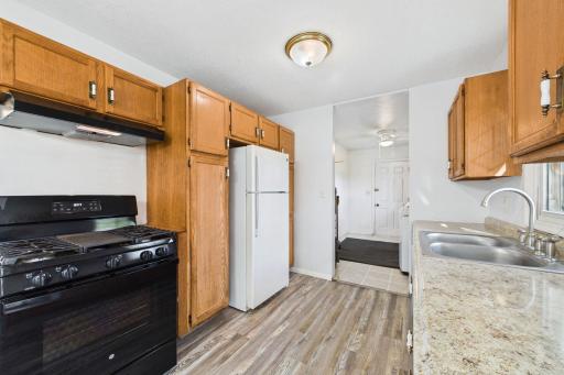 Kitchen equipped with abundant cabinetry and large prep surfaces.