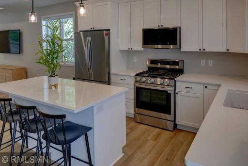 Newer construction with stainless steel appliances including a gas range.