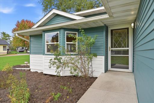Covered front entry surrounded by landscaping creates a welcoming approach to the home.