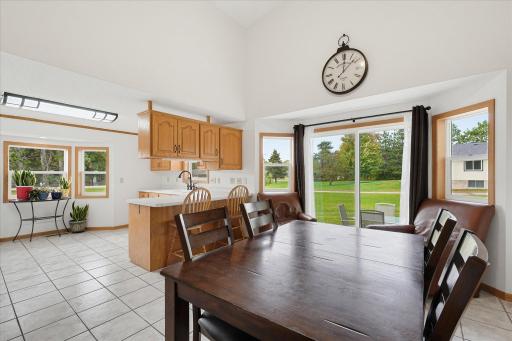 Open dining area flows seamlessly into the kitchen, with updated windows and patio access bringing in plenty of natural light.