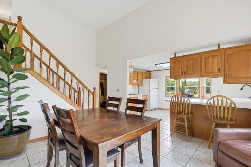 Open kitchen and dining spaces offer an easy flow for everyday living and entertaining, with vaulted ceilings and warm natural wood accents throughout.
