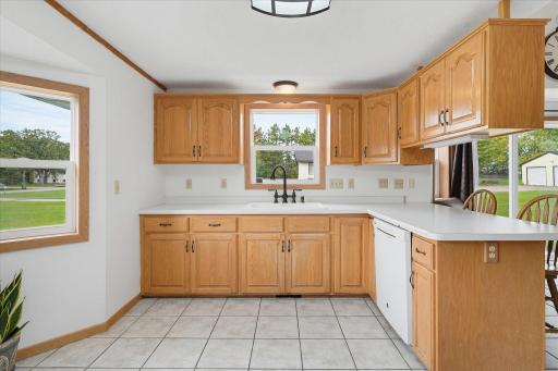Large kitchen offers extensive counter space surrounding the sink, providing plenty of room for meal prep and everyday use.