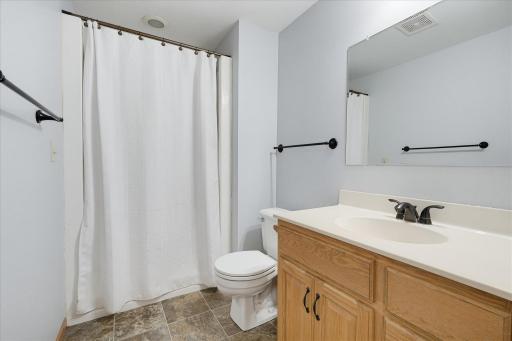 The lower level 3/4 bath has a walk-in shower, a spacious vanity and updated fixtures.