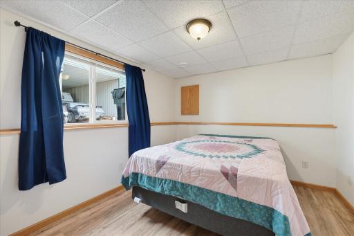 Lower-level bedroom #4 features updated LVP flooring and a spacious double closet for plenty of storage.