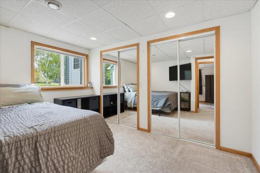 Lower-level bedroom features new carpet and two large mirrored closets offering ample storage.