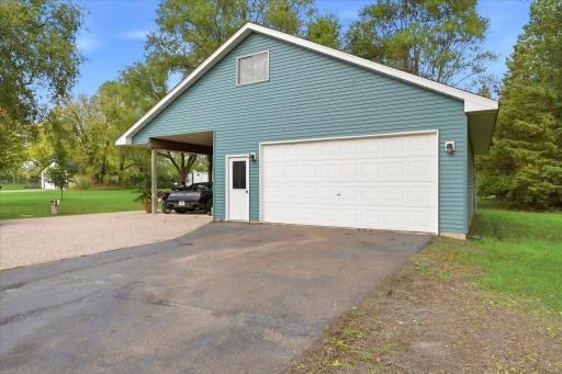 A standout feature of this property is the second detached, heated two-car garage, complete with a covered carport and pull-down attic access.