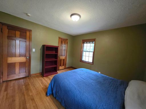 Main floor bedroom 1 with beautiful original woodwork