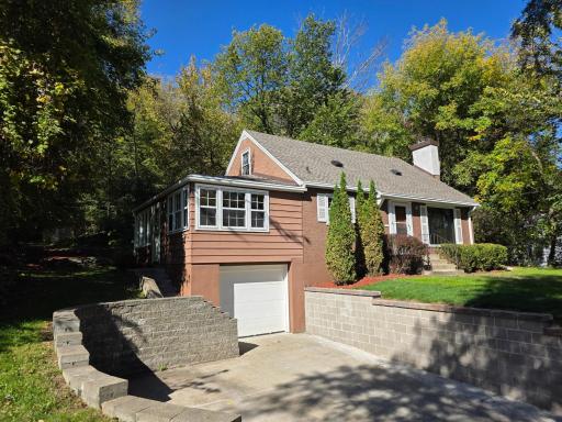 Front with new retaining wall and chimney cap in 2026