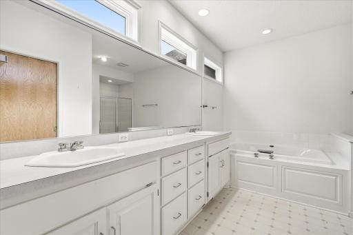 A spacious ensuite bath with double sinks, soaking tub and walk in shower completes the comfortable primary suite!