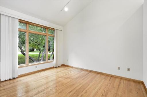A generous formal dining area shines with natural light through large windows, creating an inviting setting for memorable meals and gatherings!