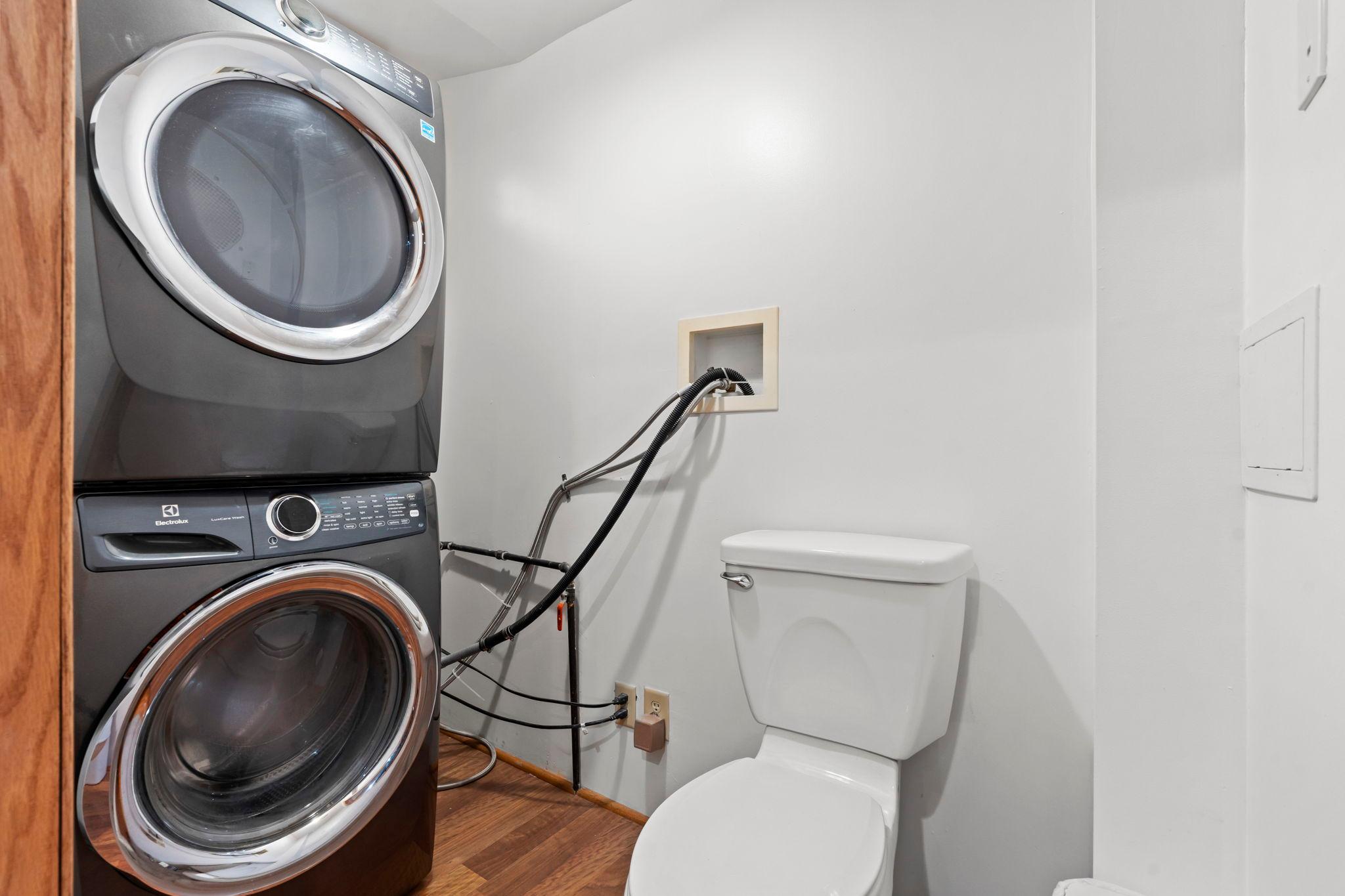 Main floor half bath with stackable laundry