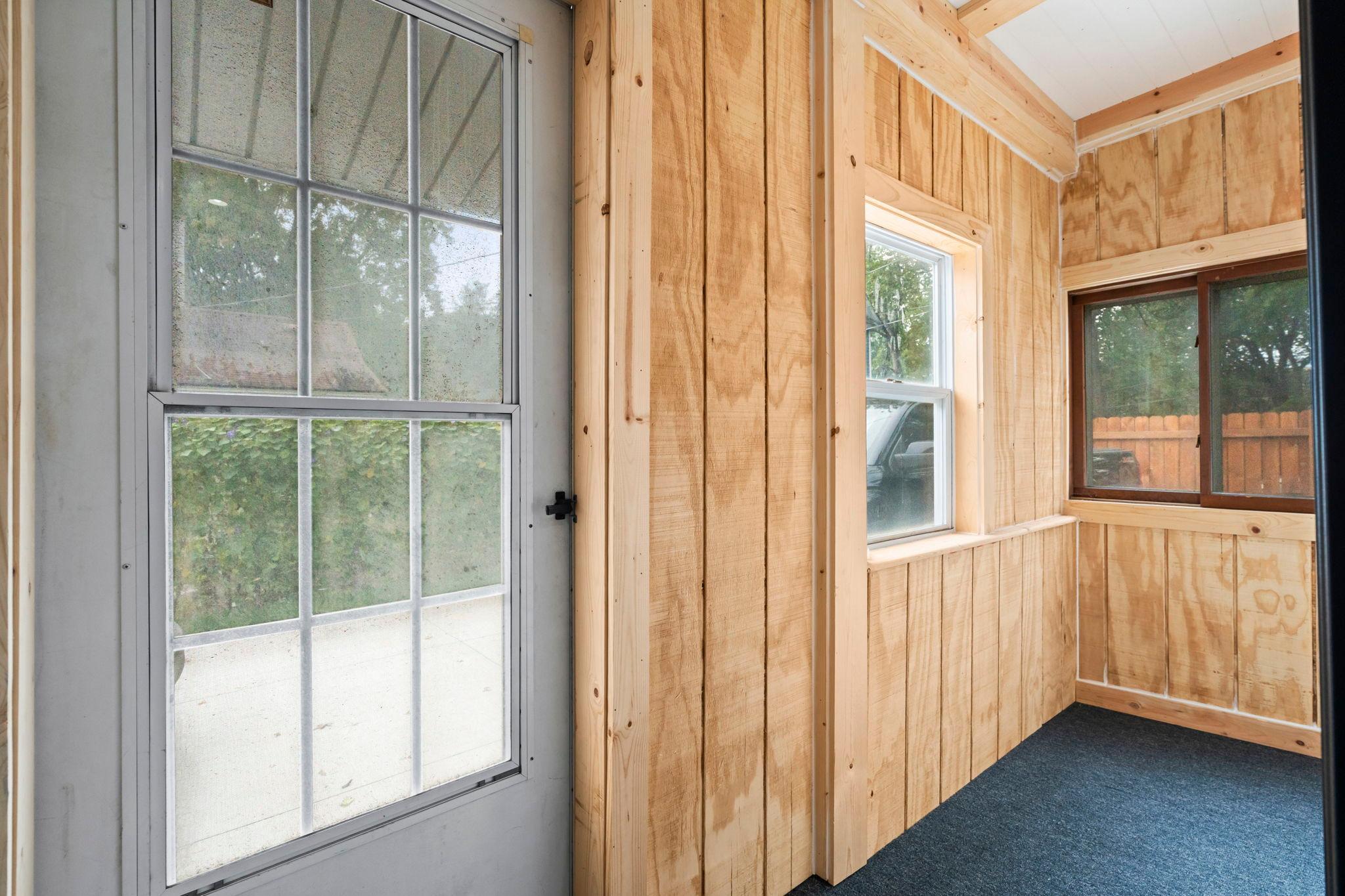 Back entrance has a screened/windowed porch