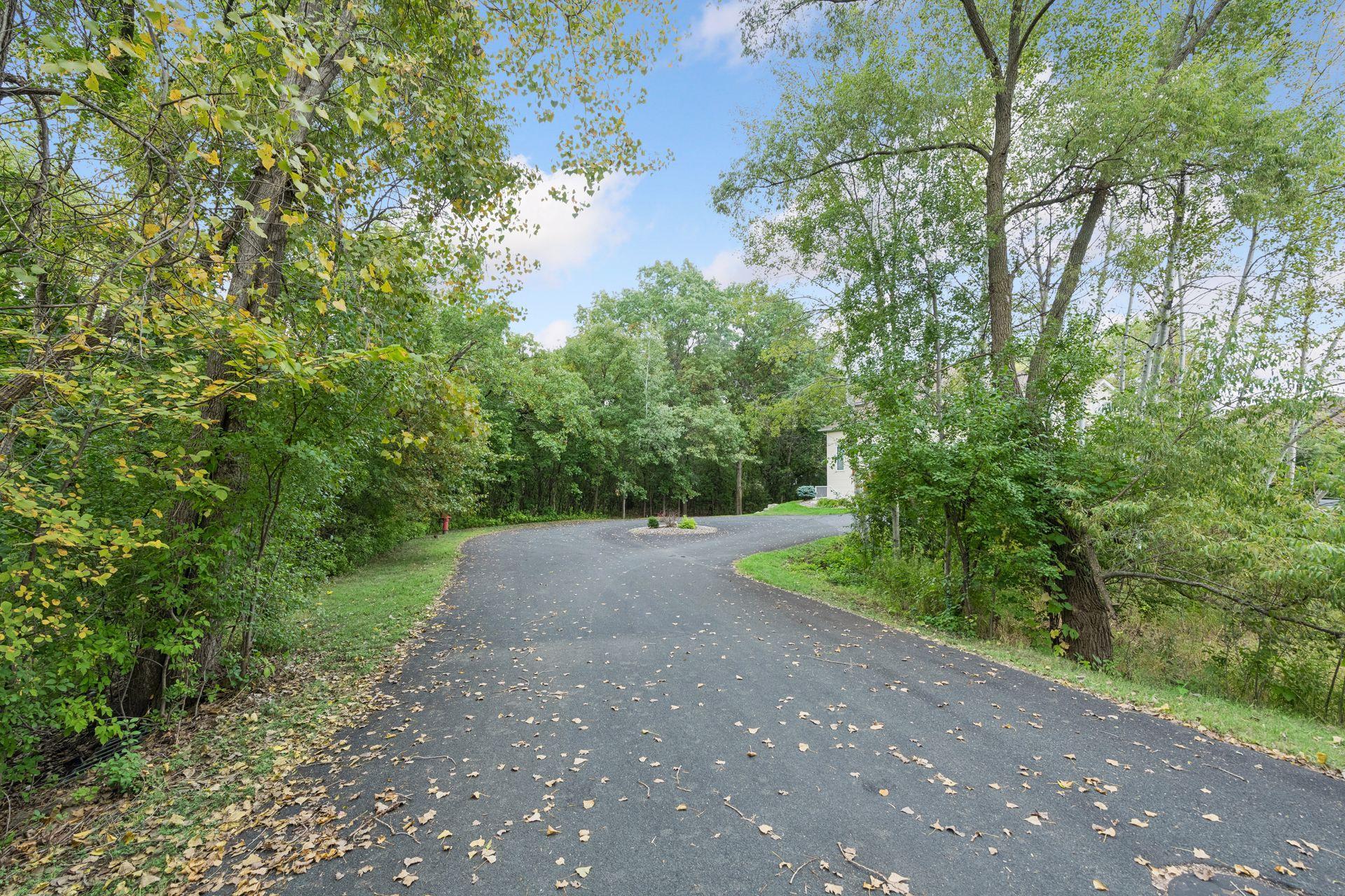 Driveway begins at the circle! Pictured is the Private Drive coming off Lac Lavon