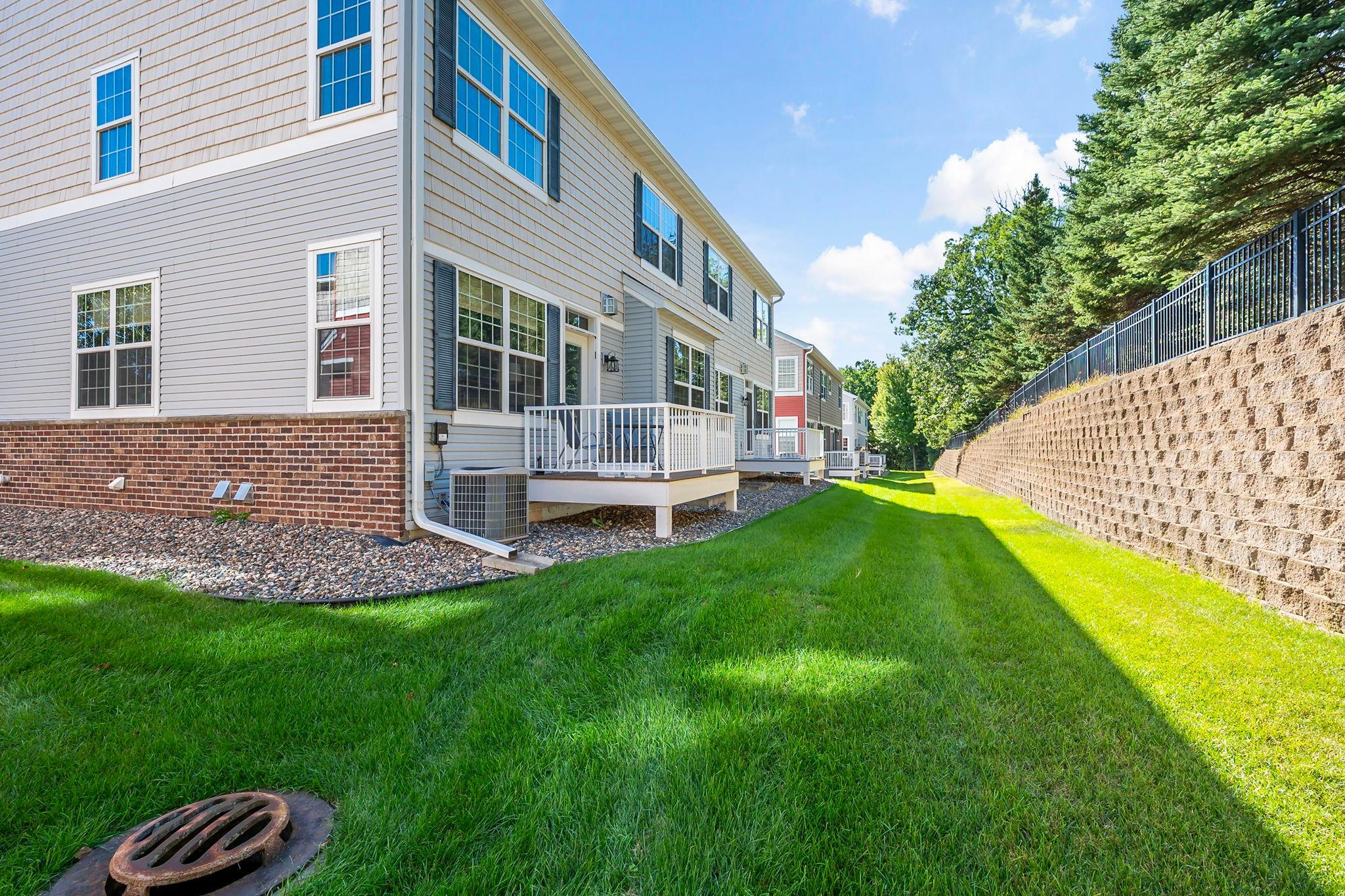 Private deck overlooking the landscaped backyard and mature trees.