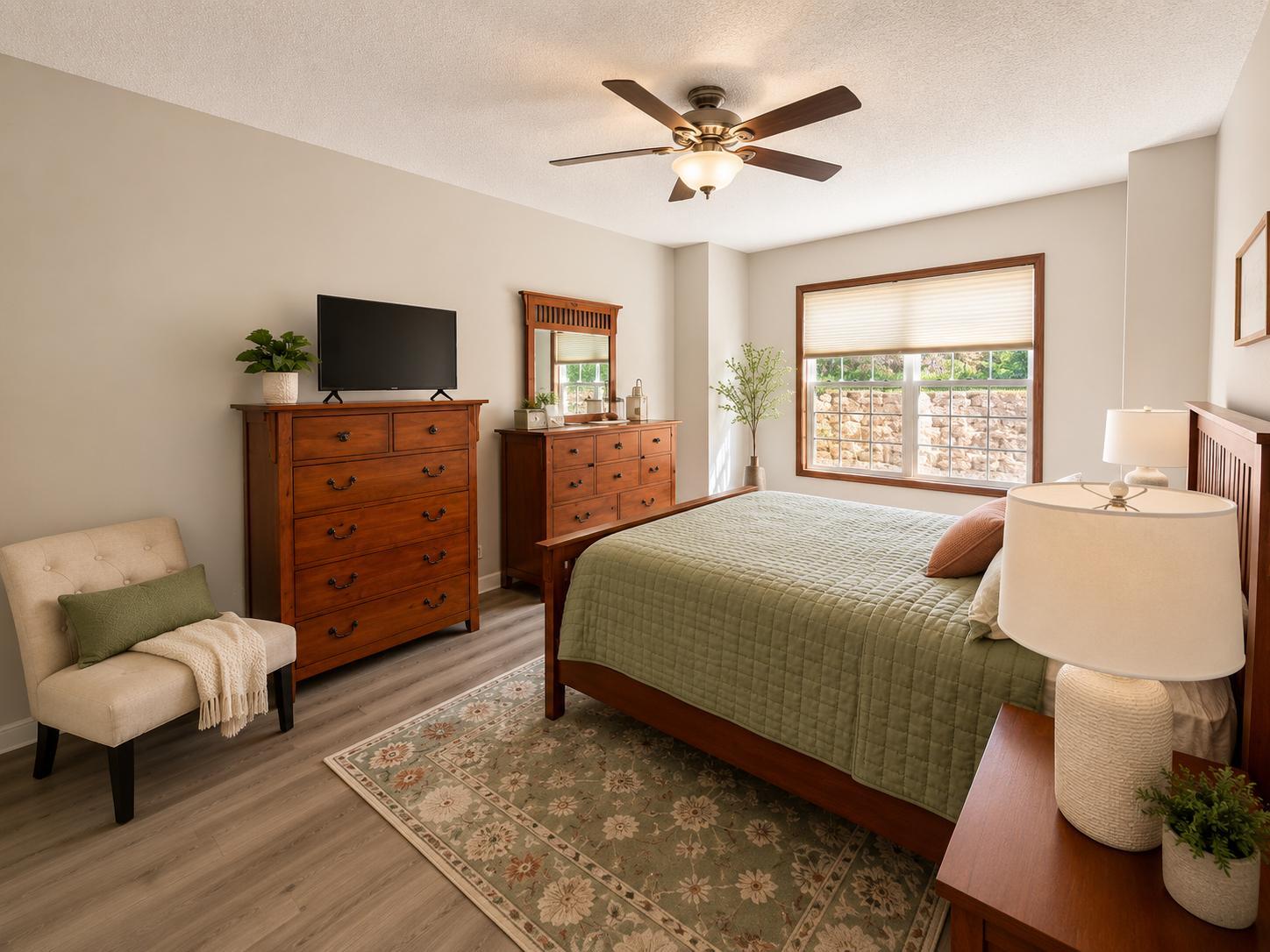 Spacious primary bedroom with neutral finishes, large window and abundant natural light.