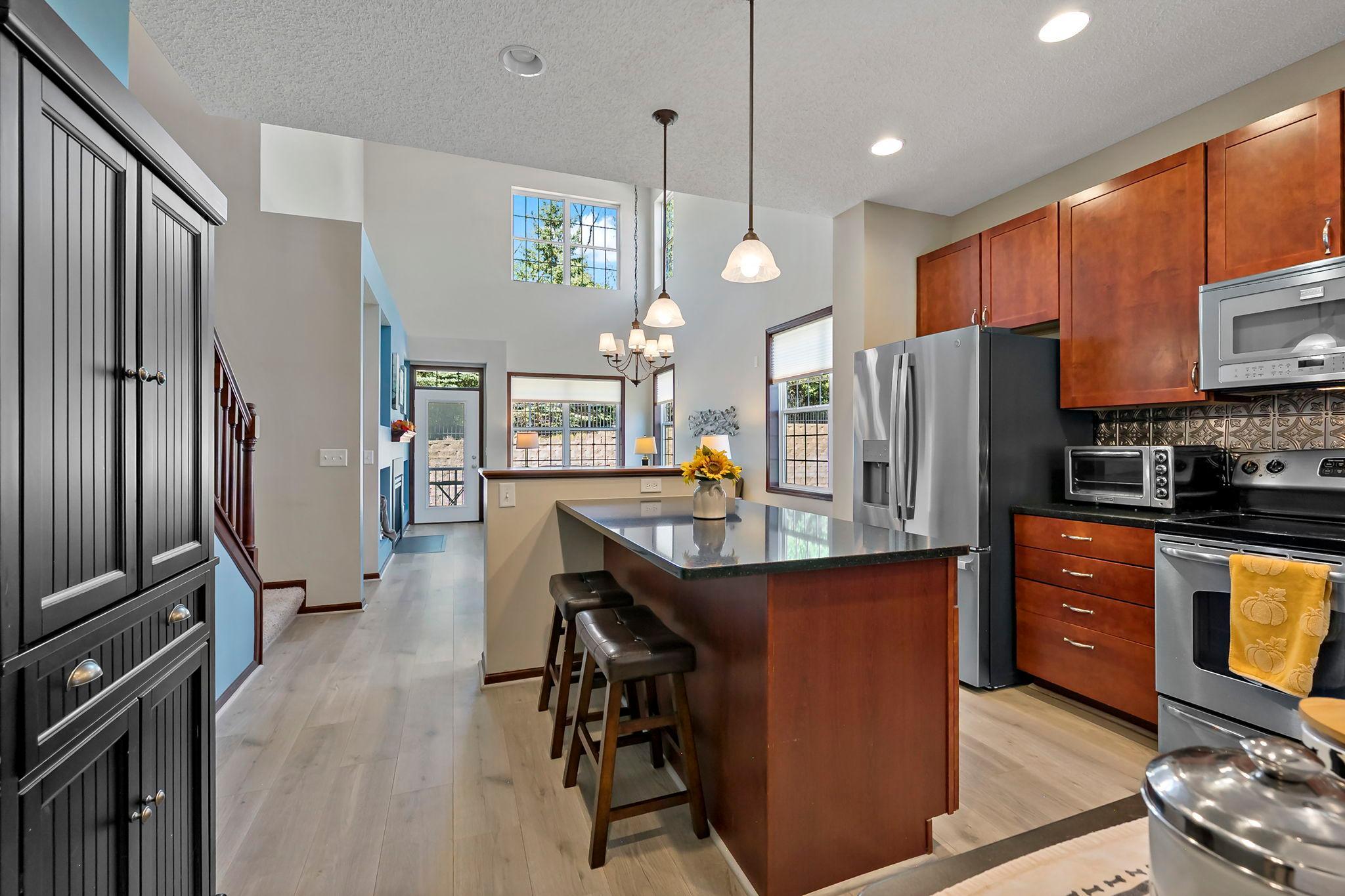 Kitchen and dining area with center island, stainless appliances and open-concept layout.