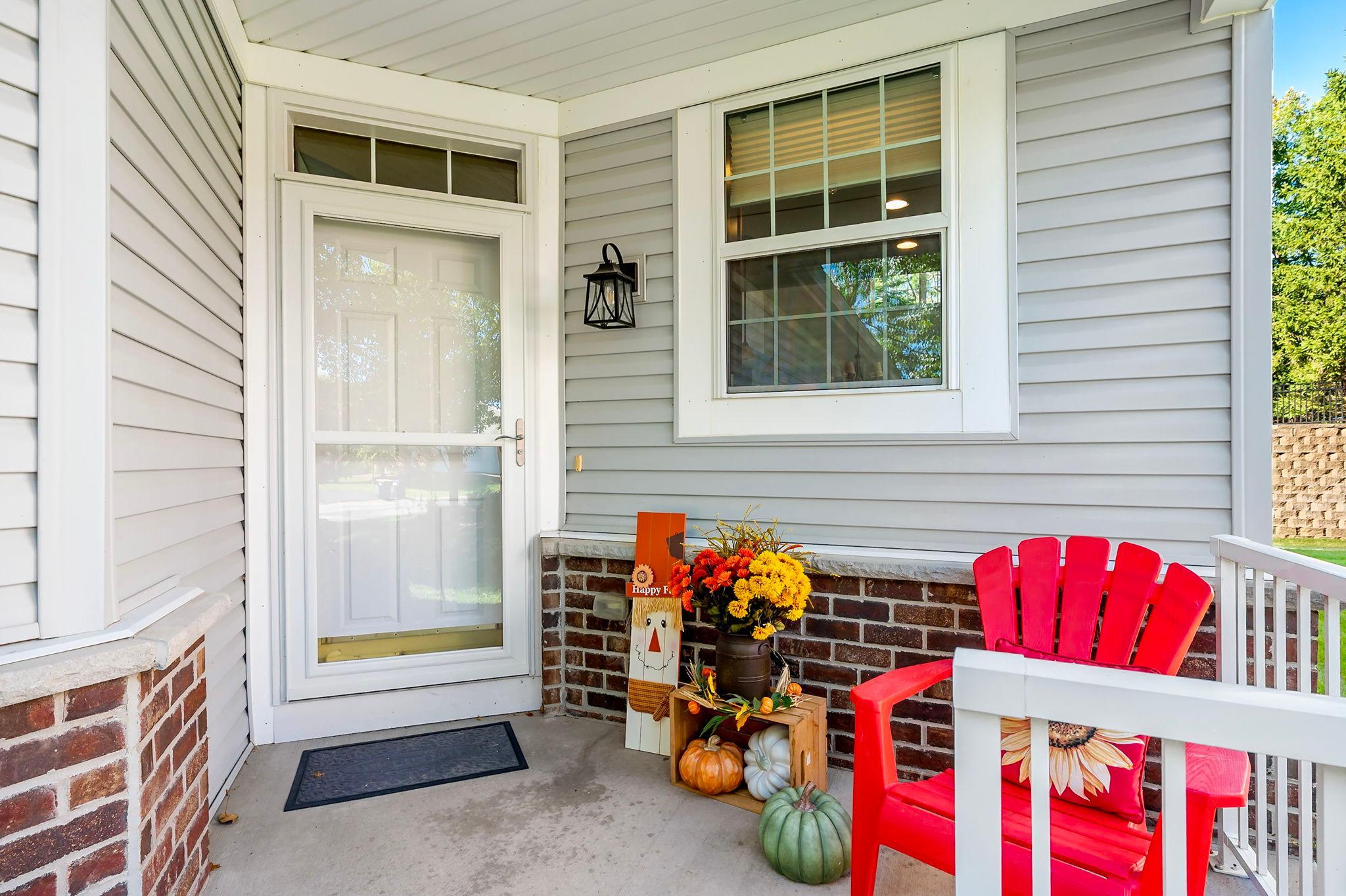 Welcoming front porch with a charming sitting area.