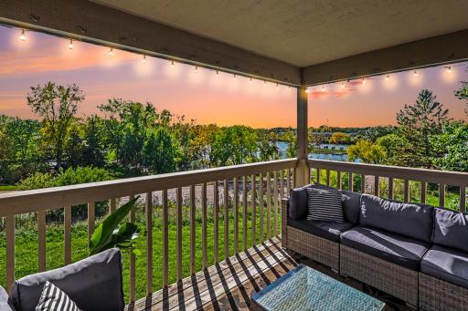 Large, end unit balcony with serene view of nearby lake and greenery