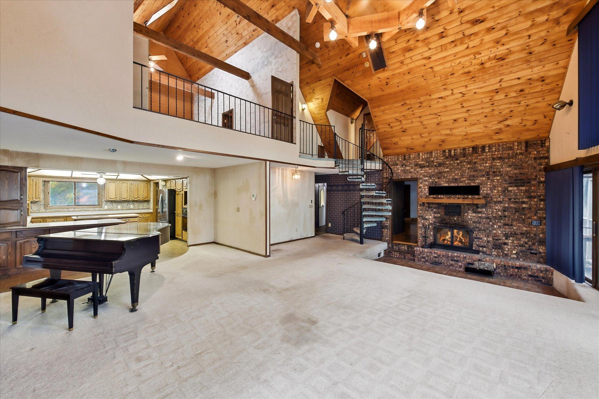Lofted primary bedroom overlooking the living room
