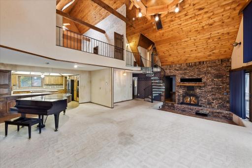 Lofted primary bedroom overlooking the living room