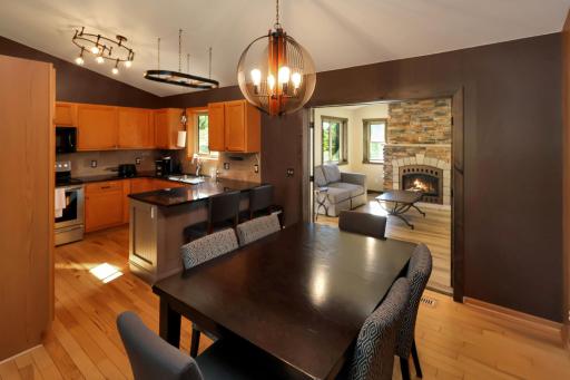 The dining room opens up to the kitchen sunroom and the living room behind this photo.