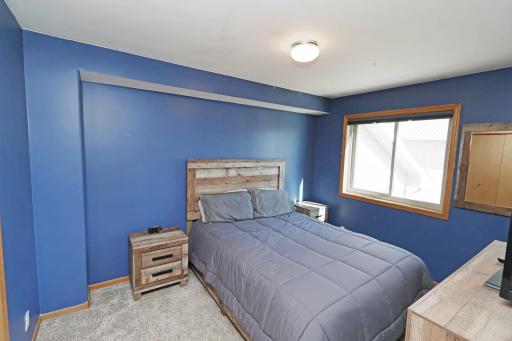 The second bedroom in the upper level offers lots of natural light.