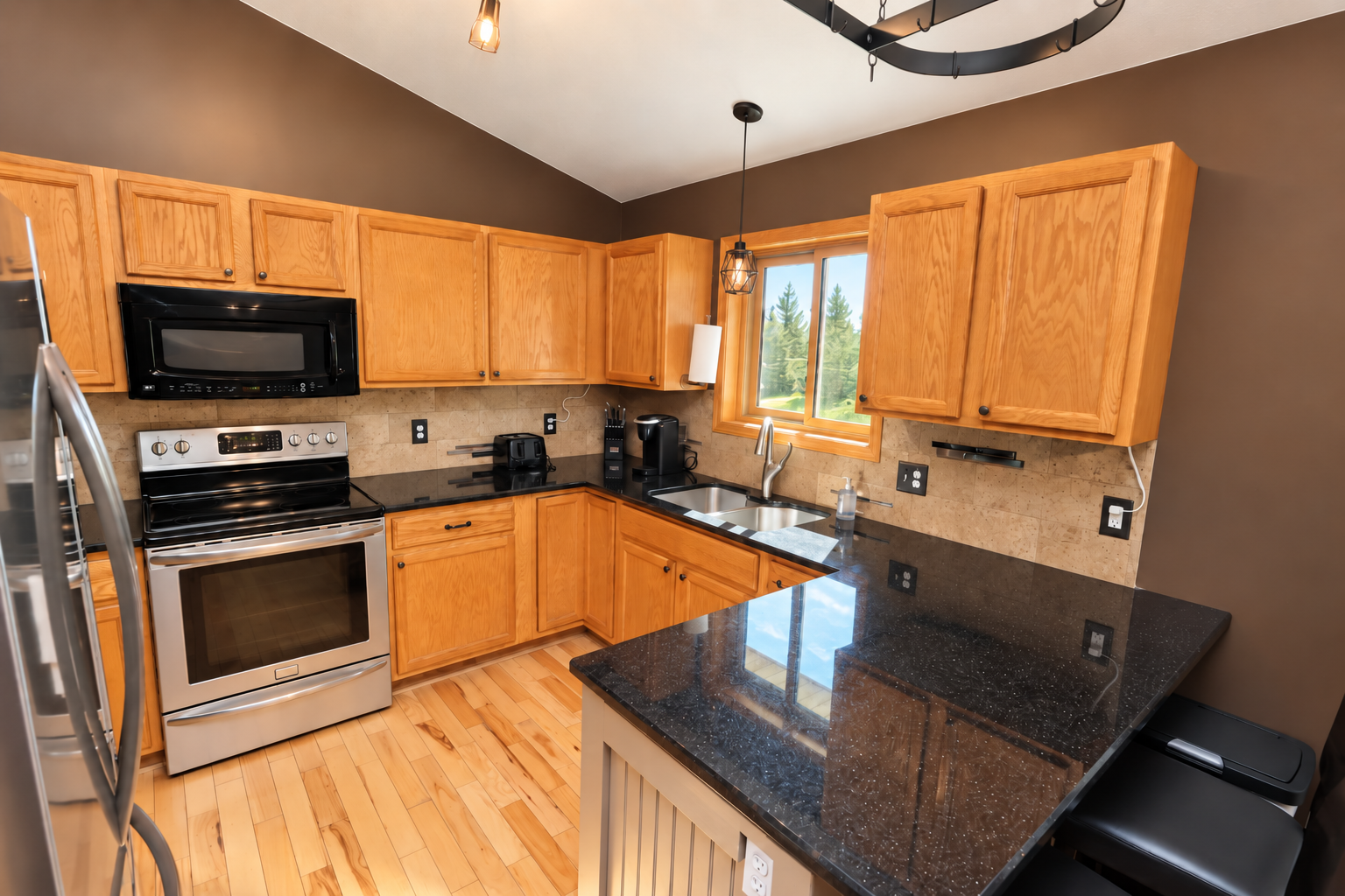 Updated kitchen with granite countertops and a great view of the backyard.