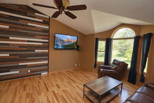 The vaulted ceilings and rount top bay window accented by the feature wall really add a warmth to the living room.jpg