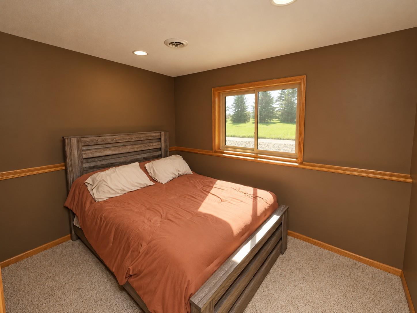Lower level bedroom three looks out to the backyard.jpg