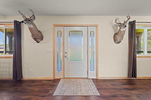 The front door of the home coming in from the front porch.