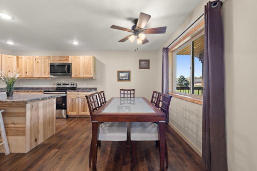 The dining area features plenty of natural light from the large window that faces the front porch and driveway.