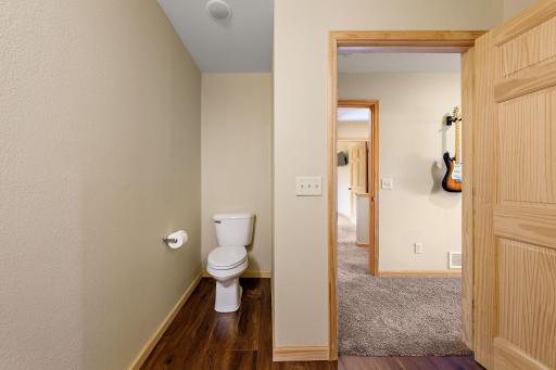 The ensuite bathroom stool is located in a private nook to the immediate right of the door upon entering the bathroom.