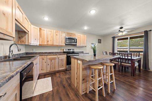 The kitchen and dining area are bright with a large window view of the front of the home.