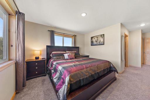 The primary bedroom with the walk in closet and ensuite bathroom doors visible on the right.