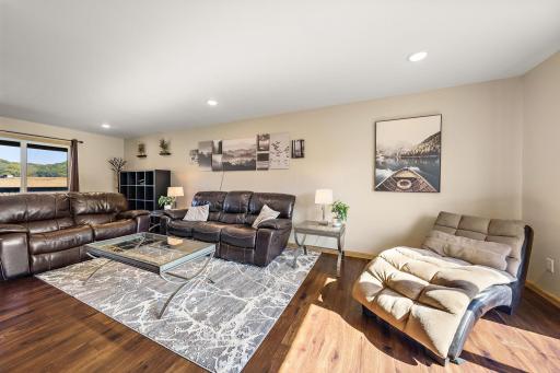 The living room has plenty of natural light from the front window on the left that looks out to the front porch and driveway and light also from the backyard patio window to the right.