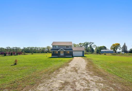 The property sits back on the lot allowing a nice view of the home as you drive up the gravel to the garage.