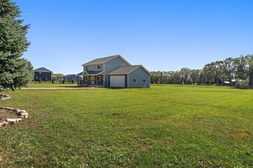 A view from the side of the yard, showcasing the possibilities of the yard with room for gardening.
