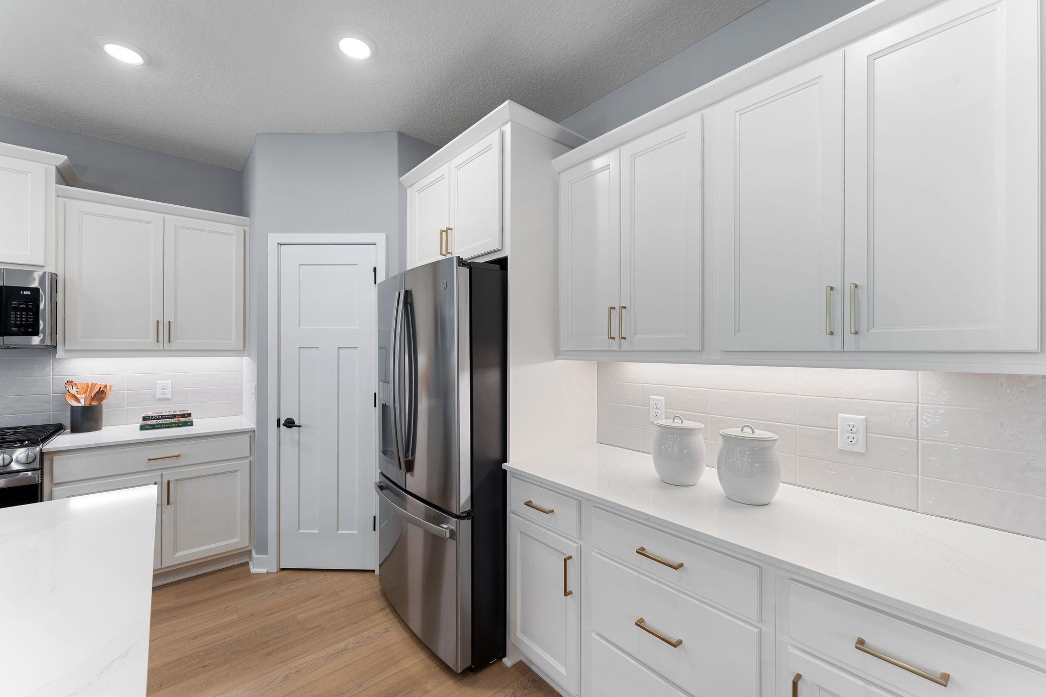 With generous cabinet space, clean finishes, and room to spread out, this kitchen is built for both busy mornings and laid-back nights in *photo of model home (design options may vary)