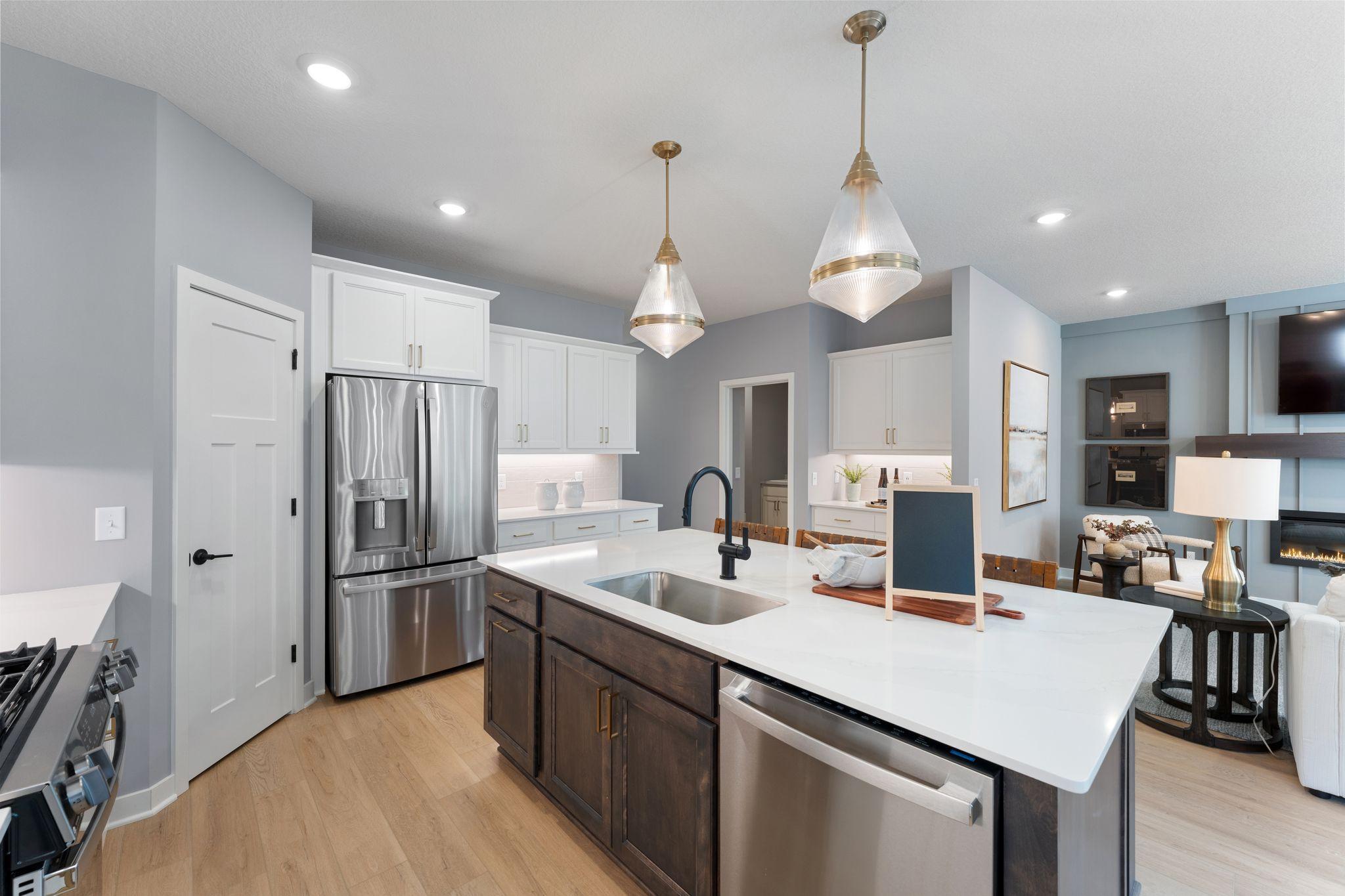A kitchen that keeps everyone connected, with a statement island, sleek finishes, and space to spread out *photo of model home (design options may vary)