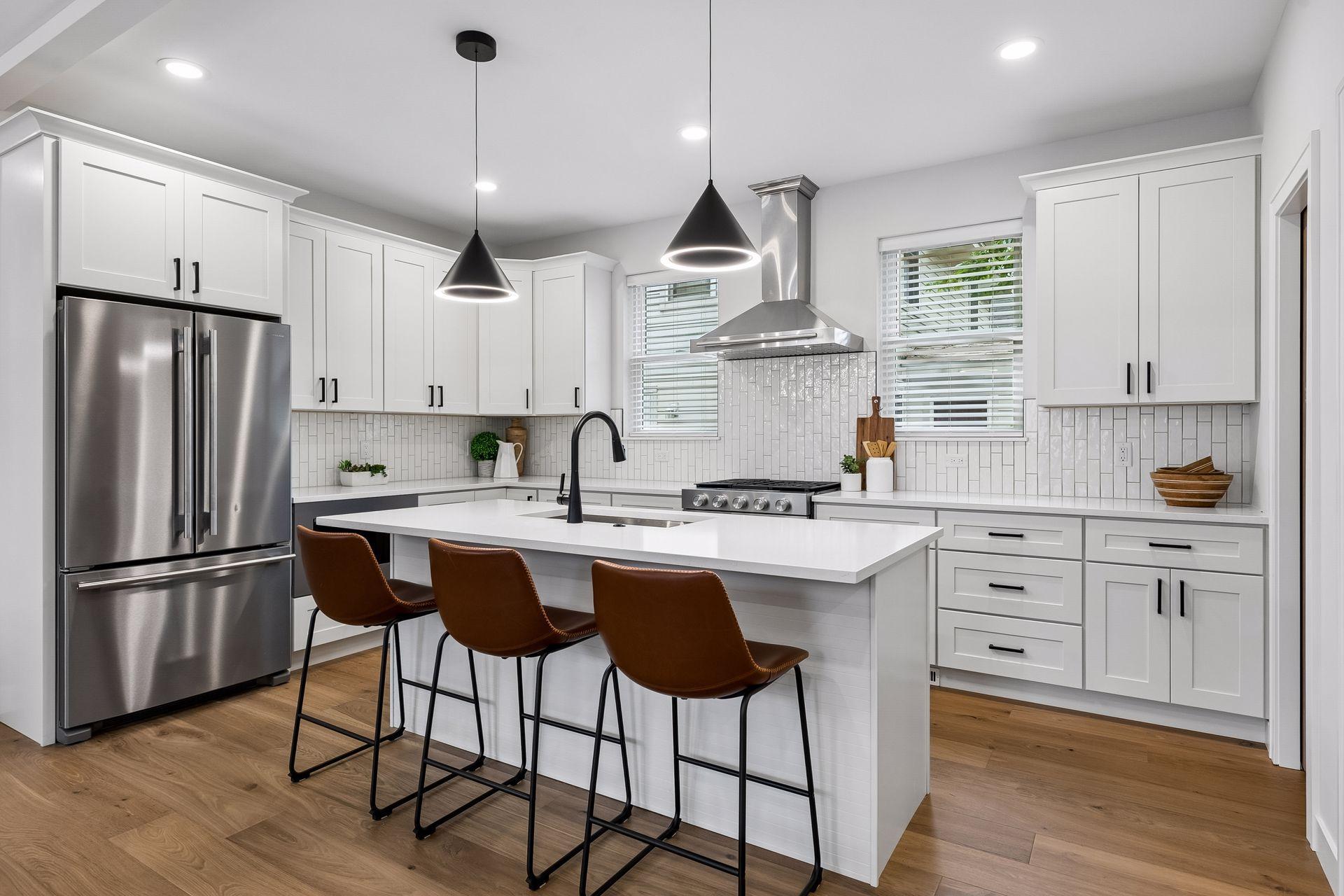 Spacious kitchen with quartz, hardwood, and upgraded appliances