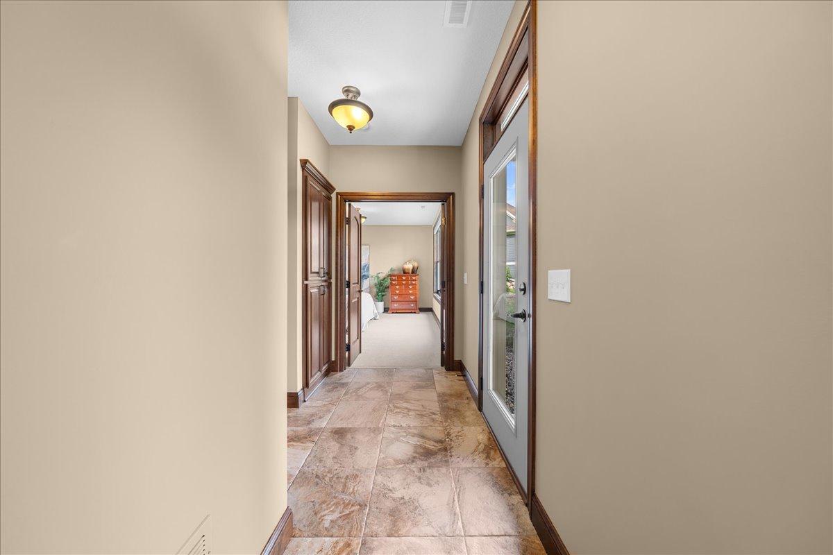 Lower level mud room has separate entrance that leads to a 3/4 bathroom with pebbled floor shower. Area was designed with future pool access in mind.