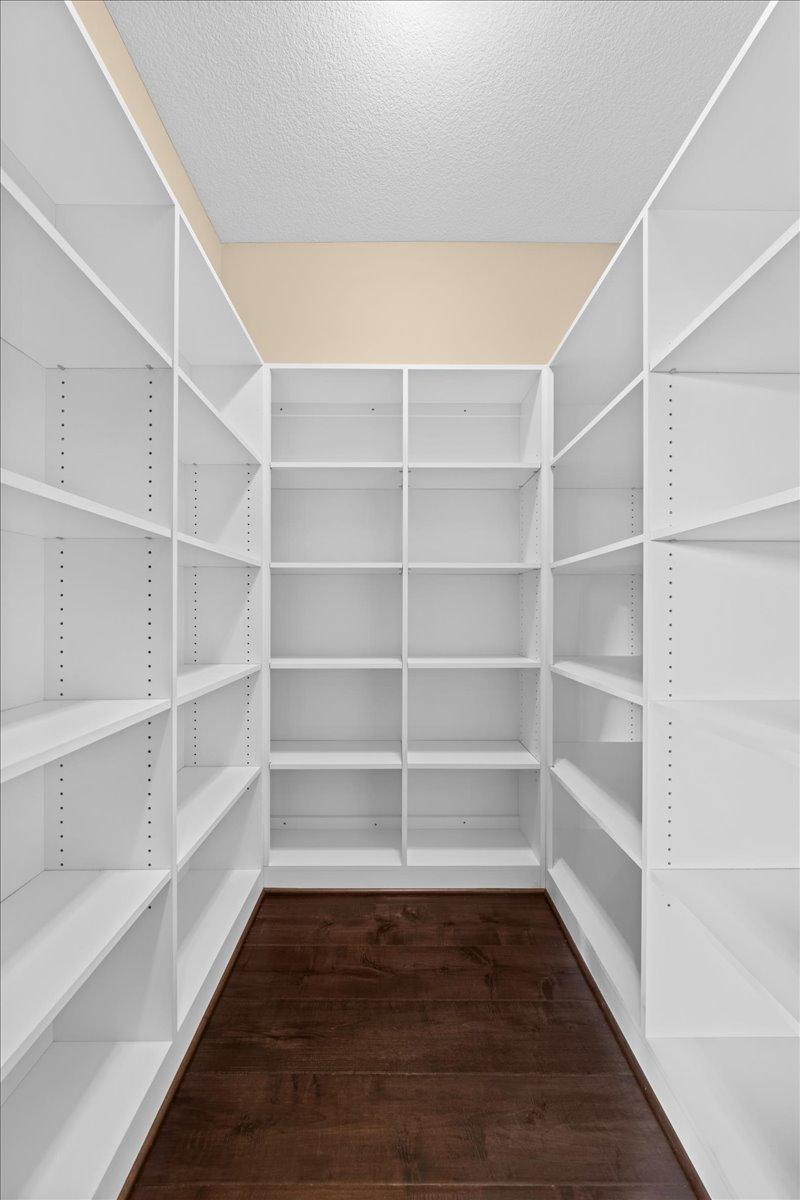 11x6 walk-in pantry with lots of shelving waiting to be filled.