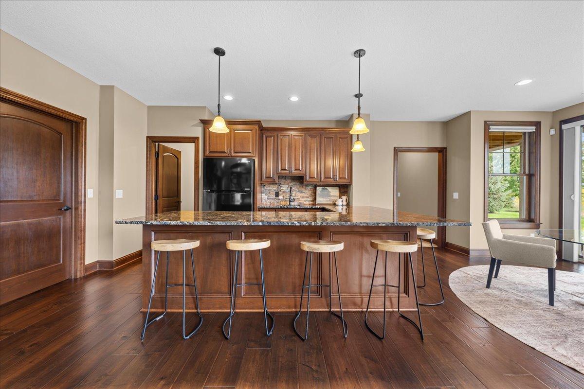L-shaped bar is fully equipped to entertain guests.